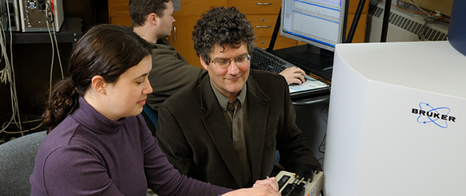 Professor and student at computer