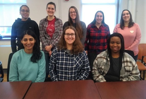 Group photo of the WCC executive board members sitting/standing behind a conference table.