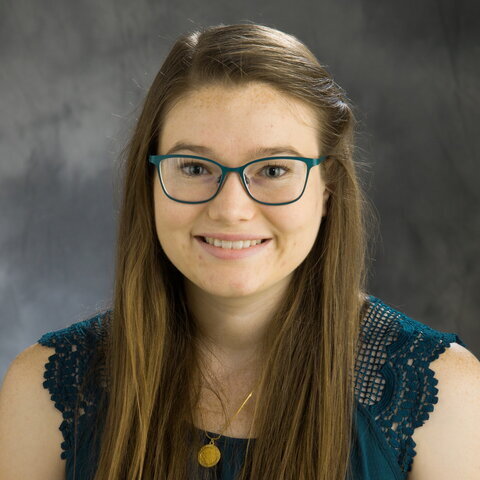 Head shot of Emily Mumford on a gray background