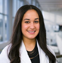 Portrait of Melanie in a lab setting with windows in background