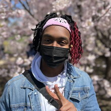 Robert Cook in front of the blooming trees at the Japan House on the UIUC campus.