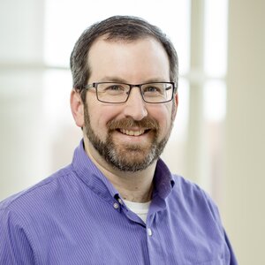 Head shot of Josh Vura-Weis on a light background inside a building.