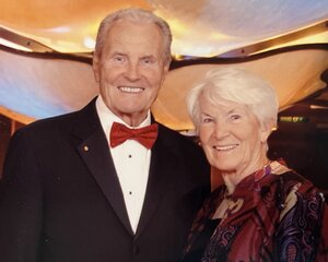 A portrait of Jiri and Ana Jonas standing side by side in formal attire. 