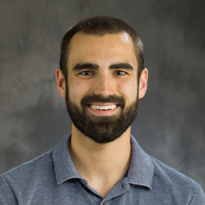 Head shot of Matthew Boudreau on a gray backgroun